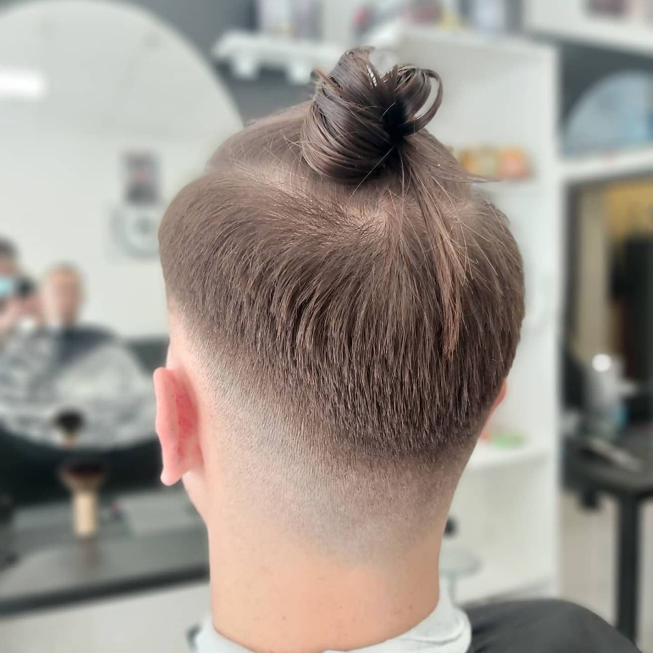 Man bun with taper fade haircut